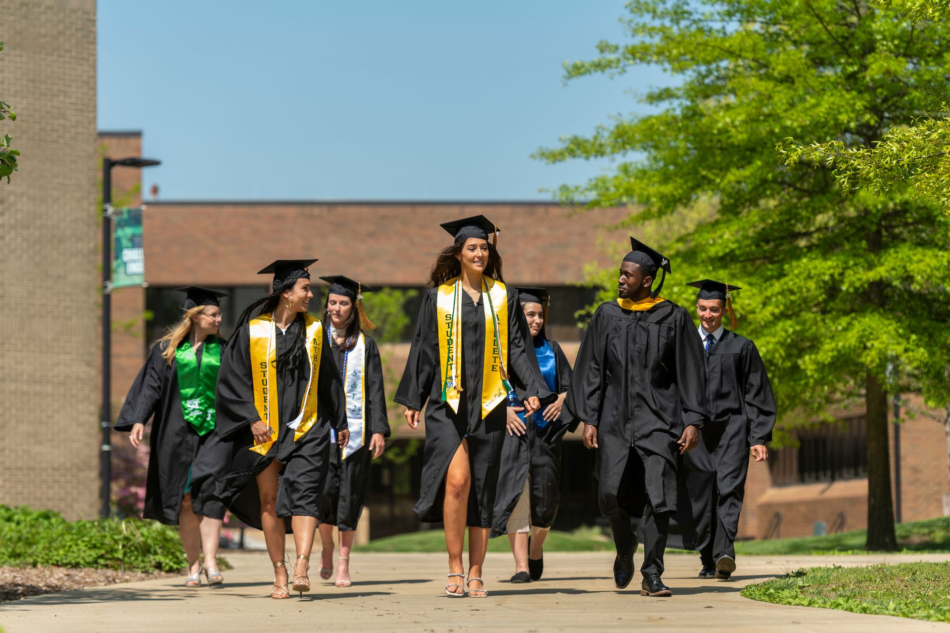 Graduating students walking on campus